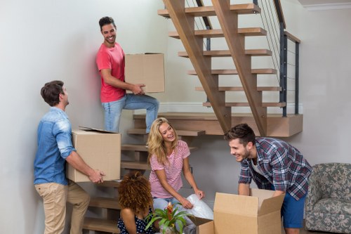 Moving team handling furniture in a central London flat