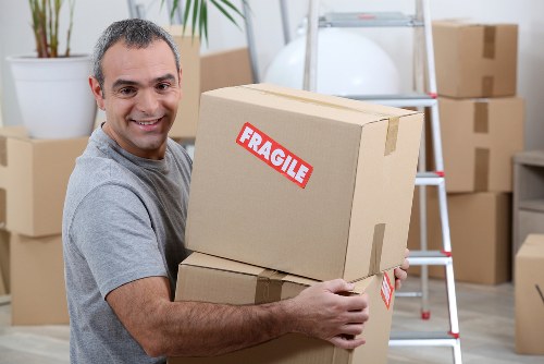 Small removals team loading furniture in Pimlico street setting